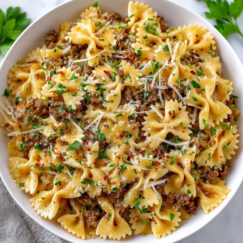Cheesy Bowtie Pasta with Savory Cajun Ground Beef in Garlic Cream Recipe